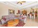 Spacious living room featuring a large sectional sofa and adjacent kitchen at 14091 Peekskill Ave, Port Charlotte, FL 33981