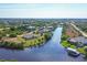 Aerial view of community with canal, homes, and lush landscape at 14091 Peekskill Ave, Port Charlotte, FL 33981