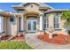 Elegant entryway with double doors, columns, and a charming fountain at 14091 Peekskill Ave, Port Charlotte, FL 33981