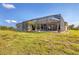 Large backyard with grassy lawn and screened pool area at 14091 Peekskill Ave, Port Charlotte, FL 33981