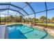 Inviting screened pool area with a tranquil water view at 14091 Peekskill Ave, Port Charlotte, FL 33981