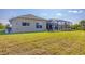 Tan house exterior with large windows and grassy lawn at 14091 Peekskill Ave, Port Charlotte, FL 33981