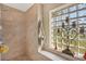 Clean bathroom with a shower and a glass block window at 14091 Peekskill Ave, Port Charlotte, FL 33981