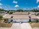 Aerial view of a community of single-story homes with a focus on the subject property at 604 Foxwood Blvd, Englewood, FL 34223