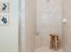 Stand-up shower with tiled walls and built-in seat at 10309 Coral Landings Ct # 101, Placida, FL 33946