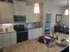 Kitchen with stainless steel appliances and ample cabinet space at 48 Long Meadow Ln, Rotonda West, FL 33947
