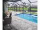 Relaxing pool area with screened enclosure and patio furniture at 48 Long Meadow Ln, Rotonda West, FL 33947