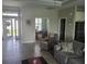Bright living room with hardwood floors and access to other rooms at 48 Long Meadow Ln, Rotonda West, FL 33947