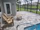 Spacious patio with pool access, chairs and table at 48 Long Meadow Ln, Rotonda West, FL 33947