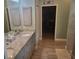 Double vanity bathroom with granite countertops and a large walk-in shower at 48 Long Meadow Ln, Rotonda West, FL 33947