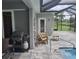 Grill and patio furniture near refreshing pool at 48 Long Meadow Ln, Rotonda West, FL 33947