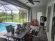 Outdoor patio with table and chairs near refreshing pool at 48 Long Meadow Ln, Rotonda West, FL 33947