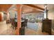Open living and dining area with high ceilings, wooden beams, and pool view at 14234 River Beach Dr, Port Charlotte, FL 33953