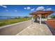 Scenic waterfront view from private balcony, featuring a gazebo and manicured lawn at 14234 River Beach Dr, Port Charlotte, FL 33953