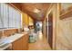 Functional laundry room with wooden cabinets and flooring at 14234 River Beach Dr, Port Charlotte, FL 33953