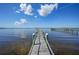 Long wooden dock stretching across the water, offering scenic views at 14234 River Beach Dr, Port Charlotte, FL 33953