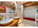 Bathroom with double vanity, red tub, and gold accents at 14234 River Beach Dr, Port Charlotte, FL 33953