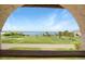 Stunning view of the water, featuring a grassy area and distant docks at 14234 River Beach Dr, Port Charlotte, FL 33953