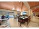 Spacious living room with vaulted ceiling, dining area, and access to the pool at 14234 River Beach Dr, Port Charlotte, FL 33953