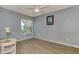 Bright bedroom with light blue walls and wood-look flooring at 570 Foxwood Blvd # 196, Englewood, FL 34223
