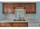 Modern kitchen with wood cabinets, quartz countertops, and stainless steel appliances at 570 Foxwood Blvd # 196, Englewood, FL 34223