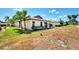 House exterior with lush landscaping and partial view of the neighborhood at 570 Foxwood Blvd # 196, Englewood, FL 34223