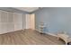 Bedroom with white closet doors and wood-look flooring at 570 Foxwood Blvd # 196, Englewood, FL 34223