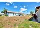 Side view of the house showing the backyard and landscaping at 570 Foxwood Blvd # 196, Englewood, FL 34223