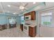 Bright kitchen features white appliances, wood cabinets, and a breakfast nook at 570 Foxwood Blvd # 196, Englewood, FL 34223