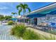 Outdoor cafe seating with blue umbrellas and lush greenery at 570 Foxwood Blvd # 196, Englewood, FL 34223
