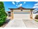 Front view of an attached garage with stone accents at 570 Foxwood Blvd # 196, Englewood, FL 34223