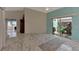 Spacious living room with marble-look floors and sliding glass doors to a patio at 570 Foxwood Blvd # 196, Englewood, FL 34223