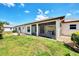 Home exterior showcasing a screened patio and grassy backyard at 570 Foxwood Blvd # 196, Englewood, FL 34223