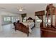 Spacious bedroom with dark wood furniture and marble floors at 570 Foxwood Blvd # 196, Englewood, FL 34223