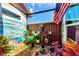 Landscaped backyard oasis with tropical plants and a charming water feature at 570 Foxwood Blvd # 196, Englewood, FL 34223