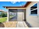 Screened porch with a walkway and gravel landscaping at 570 Foxwood Blvd # 196, Englewood, FL 34223