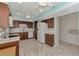 Kitchen with white appliances and wood cabinets at 570 Foxwood Blvd # 196, Englewood, FL 34223