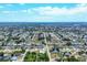 Expansive aerial view of a residential community featuring tree-lined streets and single-Gathering homes under a sunny, partly cloudy sky at 254 Orlando Blvd, Port Charlotte, FL 33954