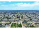 Expansive aerial view of a residential community featuring tree-lined streets and single-Gathering homes under a sunny, partly cloudy sky at 254 Orlando Blvd, Port Charlotte, FL 33954