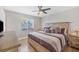 Bedroom with a ceiling fan and light hardwood floors, a queen-sized bed, and natural light at 254 Orlando Blvd, Port Charlotte, FL 33954
