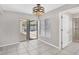 Bright, spacious bonus room leading to the patio, featuring tile flooring and a full bathroom at 254 Orlando Blvd, Port Charlotte, FL 33954