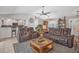 Cozy living room with leather seating, ceiling fan, and a view into the kitchen at 254 Orlando Blvd, Port Charlotte, FL 33954