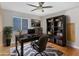 Office with a dark desk, ceiling fan, a bookcase filled with books, and an area rug at 254 Orlando Blvd, Port Charlotte, FL 33954