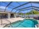Inviting screened-in pool area with seating and manicured landscaping at 254 Orlando Blvd, Port Charlotte, FL 33954