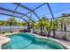 Sparkling pool inside of a screened in enclosure surrounded by lush landscaping at 254 Orlando Blvd, Port Charlotte, FL 33954
