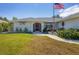 House exterior showcasing a single-Gathering home with a landscaped yard and walkway at 254 Orlando Blvd, Port Charlotte, FL 33954