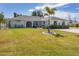 Charming home with well-manicured lawn and palm tree at 254 Orlando Blvd, Port Charlotte, FL 33954