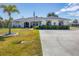 Exterior view of a single-Gathering home with a well-maintained lawn and a flag at 254 Orlando Blvd, Port Charlotte, FL 33954