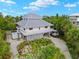Elevated view of a two-story home with gray roof at 51 Palm Dr, Placida, FL 33946