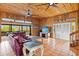Spacious living area with wood walls, access to deck, and ample natural light at 51 Palm Dr, Placida, FL 33946